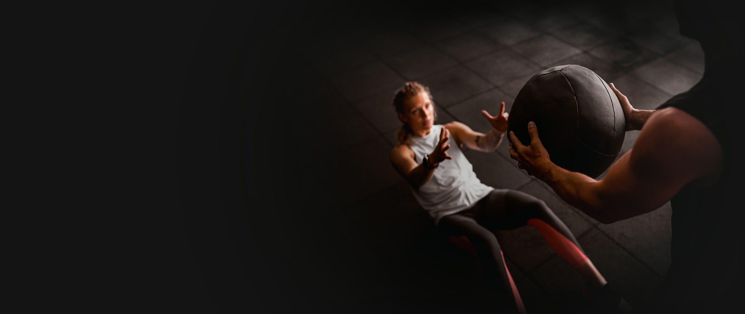 An athlete driving a medicine ball throw during a SENA session